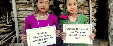 Two women from Bangladesh holding up a sign to call for the end of gender-based voilence